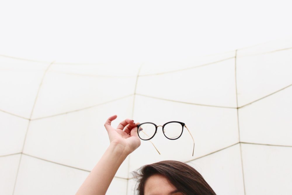 woman lifting glasses